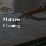 a person cleaning a mattress