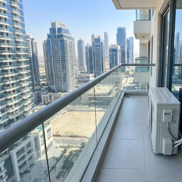 Clean apartment balcony with glass railing and AC unit after professional cleaning