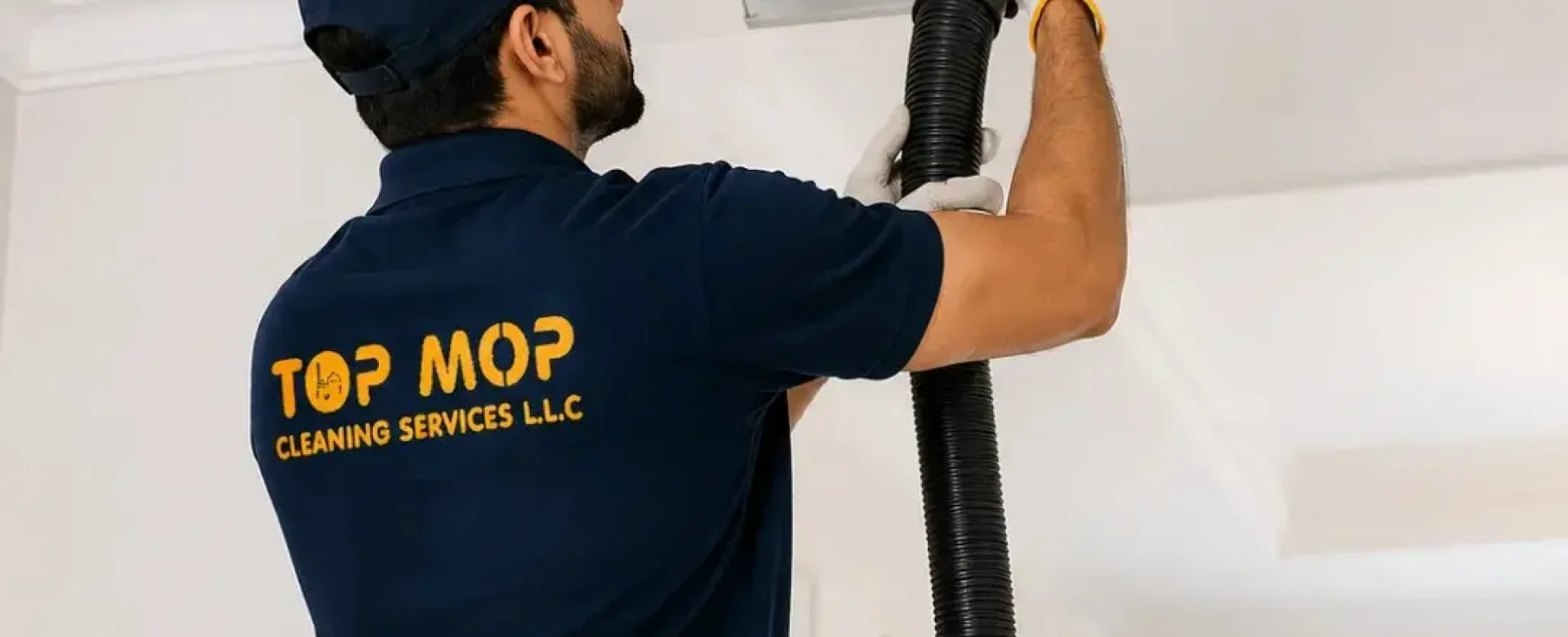Top Mop Cleaning Services technician performing professional AC duct and HVAC vent cleaning in a Dubai home to improve indoor air quality.